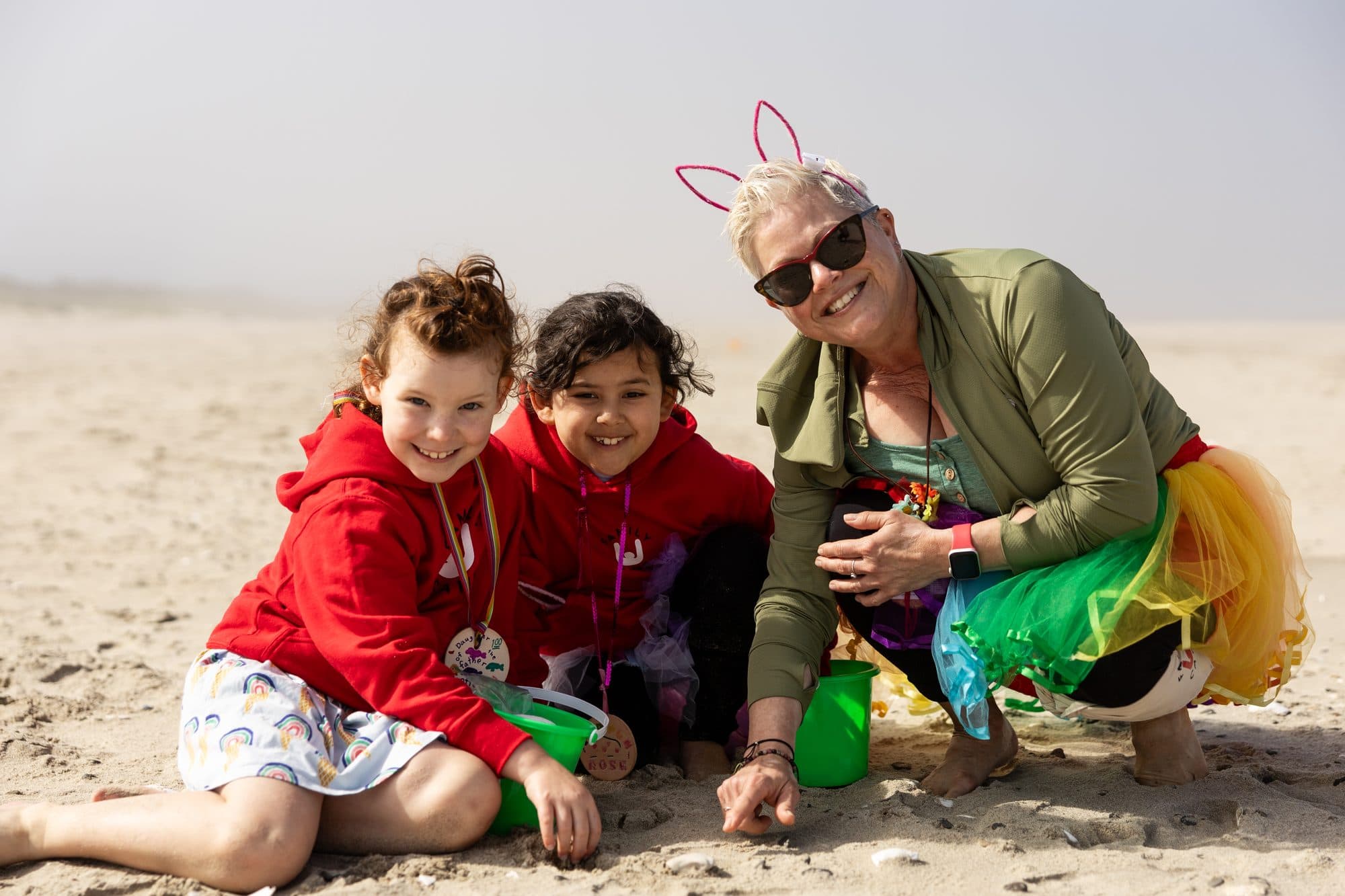 Adults and children playing in the sand