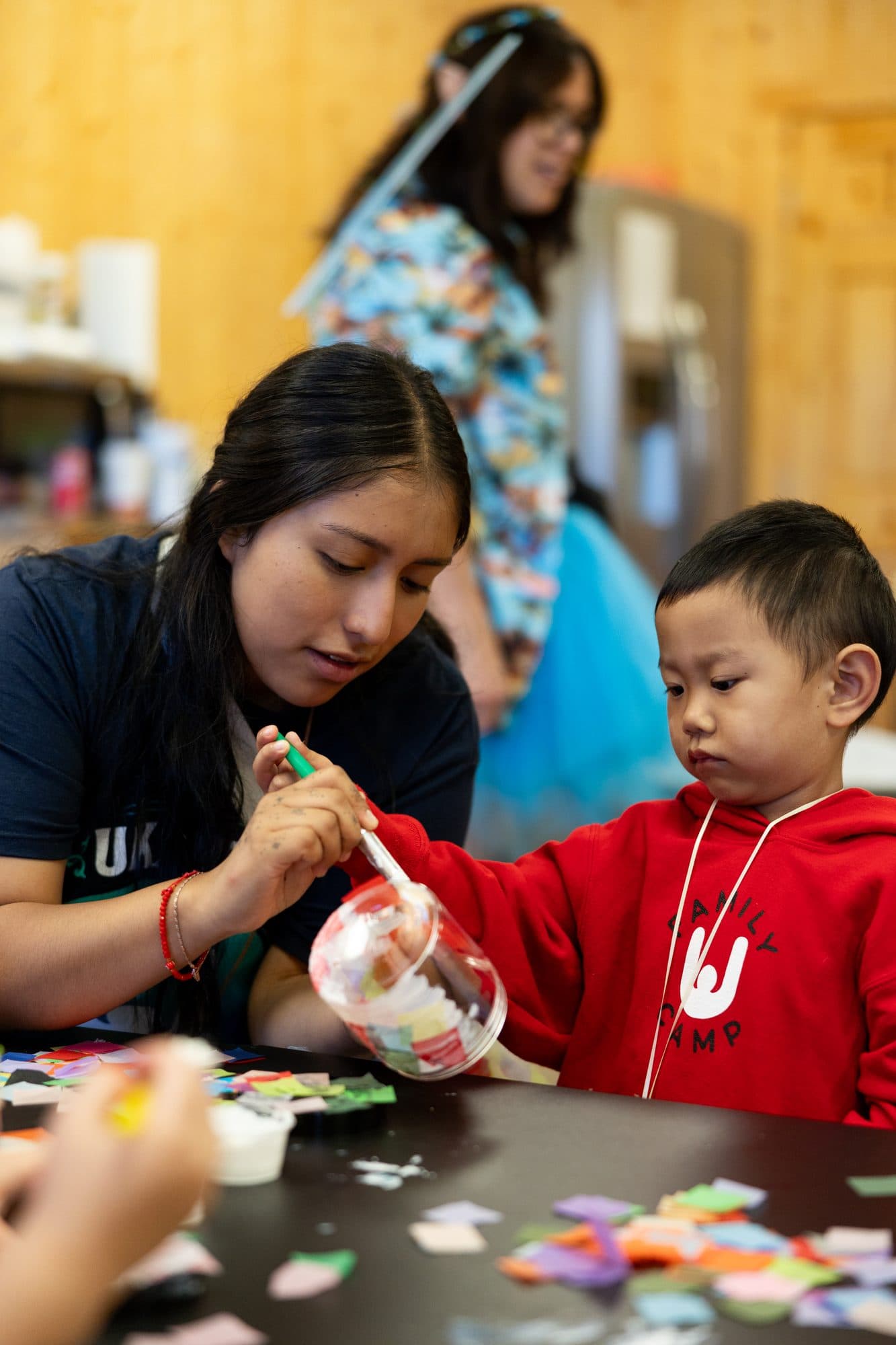 An adult and child working on an arts-and-crafts activity