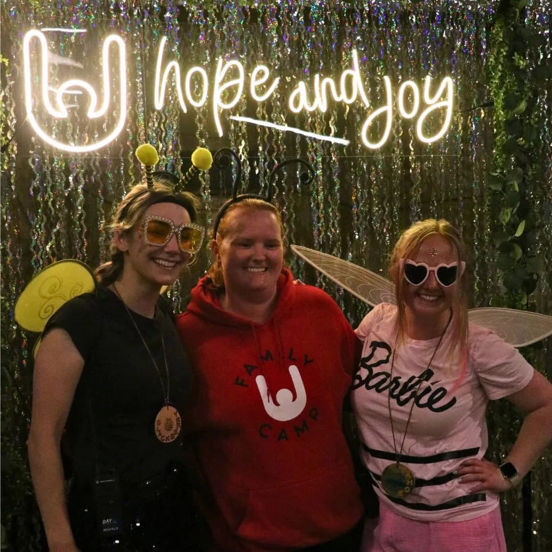 Tahoe & rainbow team with hope & joy sign